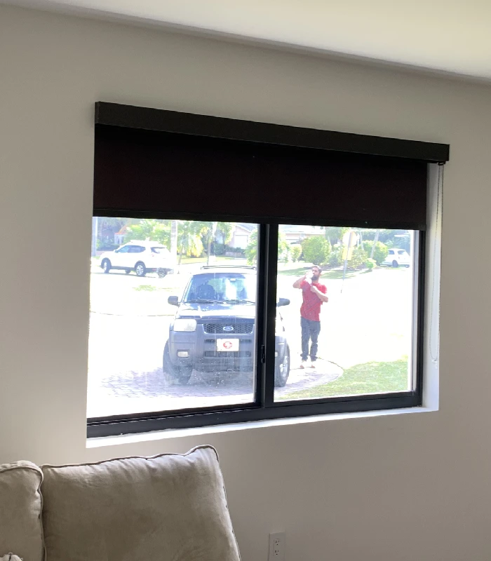 Dark blackout blinds blocking sunlight on a front window
