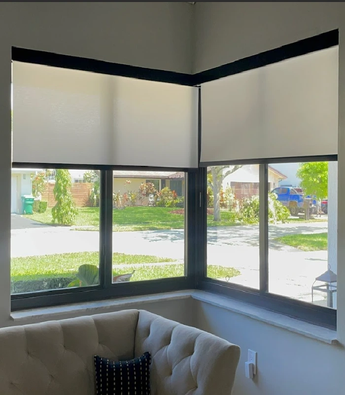 Corner windows with clean white screen blinds in daylight