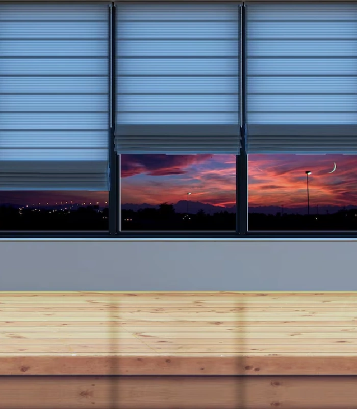 Light blue blinds partially covering sunset sky