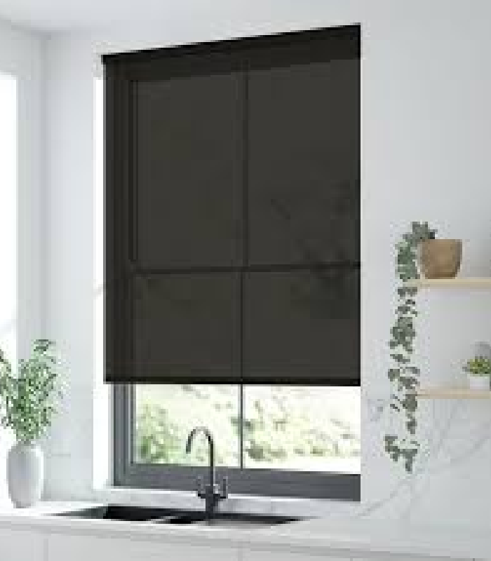 Black roller shade over modern kitchen window.