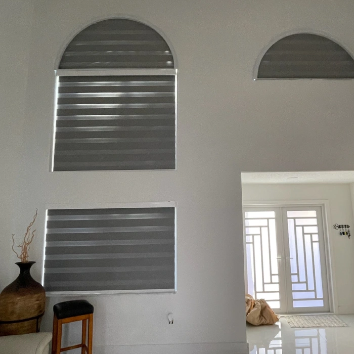 Smart motorized blinds installed in a modern Miami Shores living room.