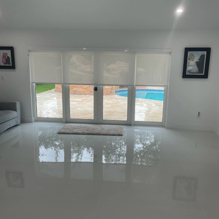 Motorized roller blinds on patio doors overlooking a pool in Cutler Bay.