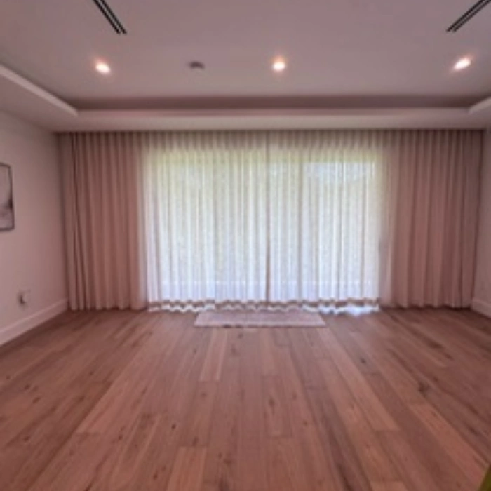 Motorized draperies with soft fabric panels installed in a modern living space.