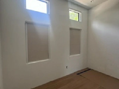 Blackout roller shade installed in large Miami kitchen window